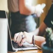 A person sitting at a computer and working